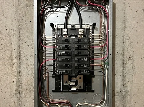 Residential electrical panel with the cover off on a basement wall